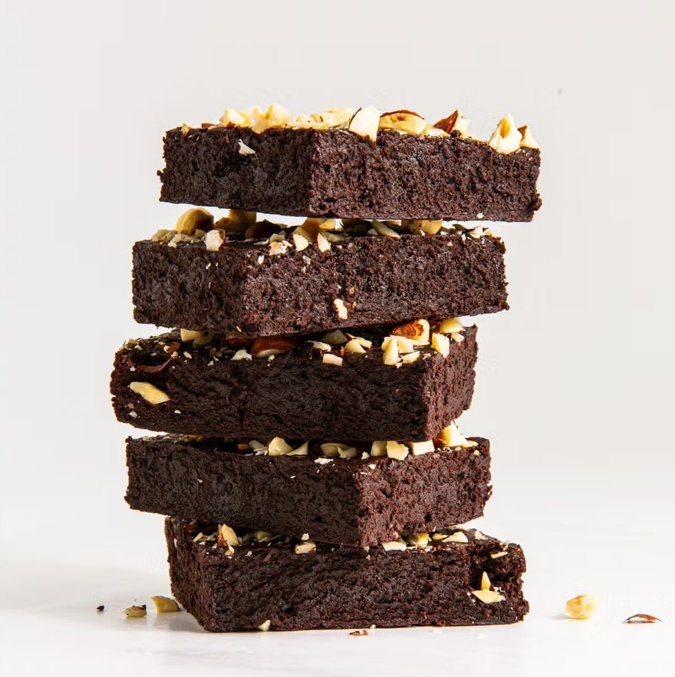 Dense, fudgy gluten-free brownies cut into squares with gooey chocolate chunks inside
